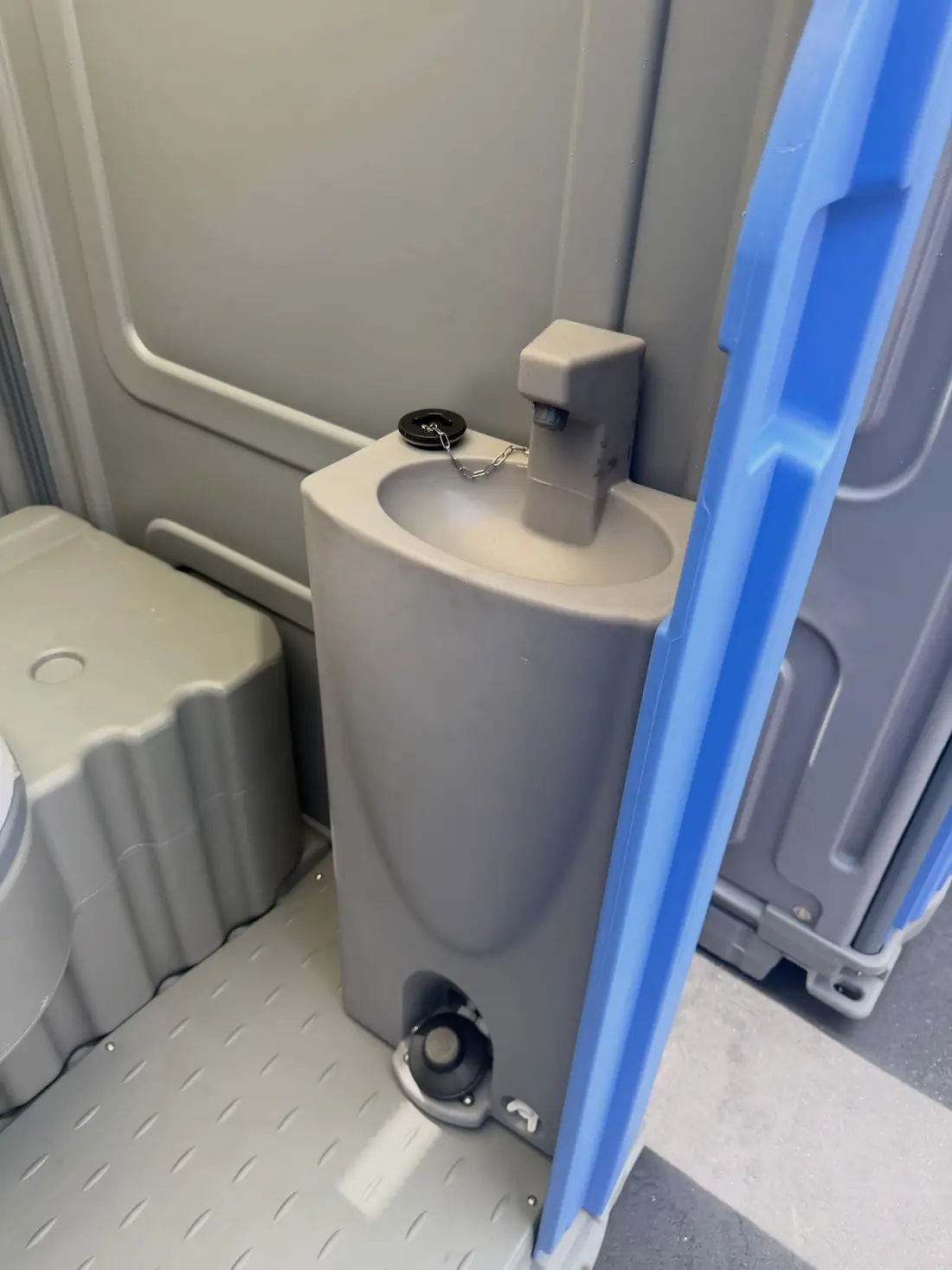 Foot-pump sink inside a deluxe portable restroom